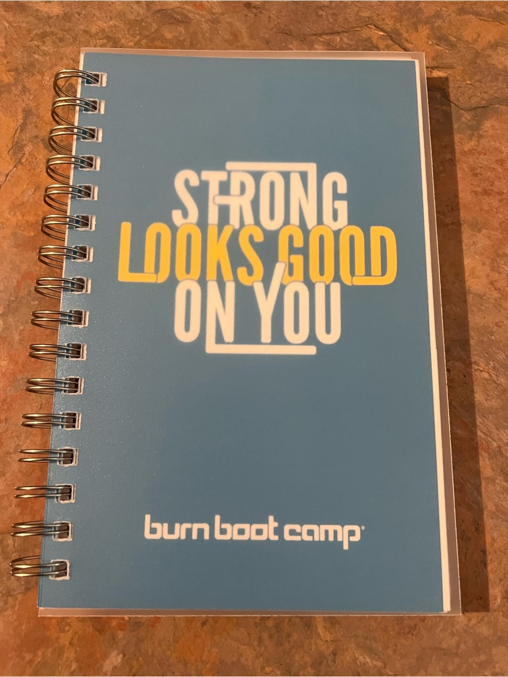 burn boot camp Blue Spiral Notebook — "Strong Looks Good On You"